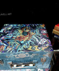 Blue painted wooden briefcase with the Vintage Tattoo decoupage paper applied on top.
