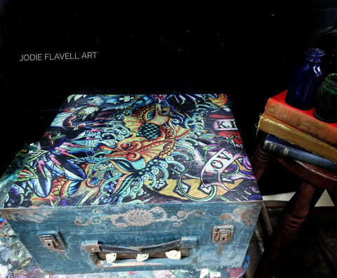 Blue painted wooden briefcase with the Vintage Tattoo decoupage paper applied on top.