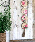 White and brown painted wooden slat board with 4 small beaded wooden circles hanging with the Vintage Wallpaper decoupage paper applied on parts of the circles.