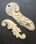 WoodUBend Applique #1320 (set of 2) is the perfect mouldable embellishment for any project! Applique #1320 (set of 2)with packaging against black background.