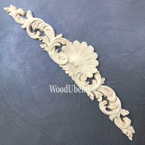 WoodUBend Applique #1372.48 (Set of 2) is the perfect mouldable embellishment for any project! This image shows one Applique #1372.48 against a black background.