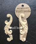 WoodUBend Applique #2437 (set of 2) is the perfect mouldable embellishment for any project! Image shows two Applique #2437 (set of 2) with packaging against a black background.