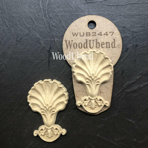 WoodUBend Applique #2447 (set of 2) is the perfect mouldable embellishment for any project!
The Applique #2447 (set of 2) is seen with one in the packaging and the other one without on a black crinkled background.