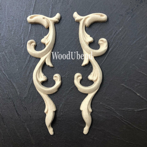 WoodUBend Applique #366-7 (set of 2) is the perfect mouldable embellishment for any project!
The Applique #366-7 (set of 2) set side by side staged on top of a black crinkled background.