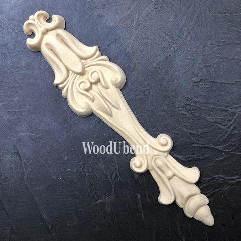 WoodUBend Applique #6039 (Set of 2) is the perfect mouldable embellishment for any project! One Applique #6039 (Set of 2) against a black background.