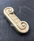 WoodUBend Applique #6081 (Set of 2) is the perfect mouldable embellishment for any project!
One of the Applique #6081 (Set of 2) is seen flat and facing to the right. Staged on a black crinkled background.