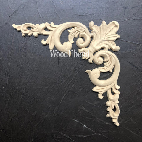 WoodUBend Corner Applique #2093 (set of 2) is the perfect mouldable embellishment for any project!
This applique is made from wood.  It is a corner piece and a Victorian feel.  This applique is resting on black leather.  This applique is perfect for someone who would like to upcycle used furniture.