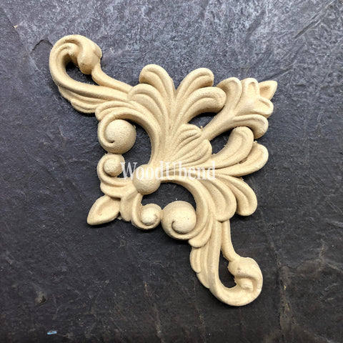WoodUBend Fleur-de-lis Applique #2443 (set of 2) is the perfect mouldable embellishment for any project!
An image of the Fleur-de-lis Applique #2443 without its packaging, staged on a black crinkled background.