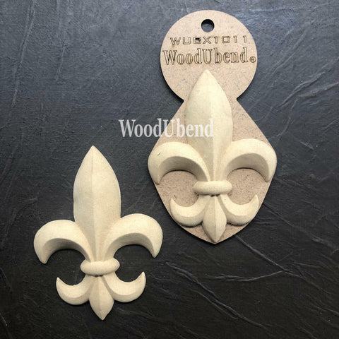 WoodUBend Fleur-de-lis Applique #X1011 (Set of 2) is the perfect mouldable embellishment for any project!
The Fleur-de-lis Applique #X1011 Set of 2, shown with one in the packaging and the second without. Staged on a black crinkled background.