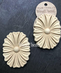 WoodUBend Floral Applique #1333.1 (Set of 2) is the perfect mouldable embellishment for any project!
Image shows the full set of Floral Applique #1333.1 staged diagonally besides each other, one in its packaging the other one out, on top of a black background.