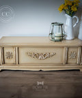 WoodUBend Floral Applique #2427 (set of 2) is the perfect mouldable embellishment for any project!
A chest painted in Burlap Chalk Mineral Paint along with Floral Applique #2427 on the front panels of the chest. Staged with a white vase with flowers.