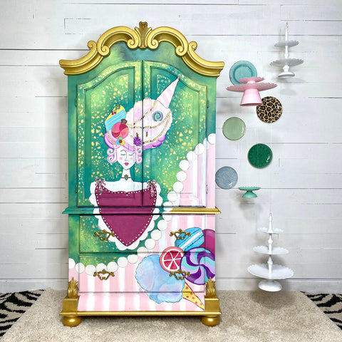 WoodUBend Keyhole #987 is the perfect mouldable embellishment for any project!
A child's wardrobe with a whimsical child candyland painting and design. The wardrobe has Keyhole #987  on the furniture piece. Staged on the walk next to the piece are ceramic plates as well as hanging cupcake and cake stands.