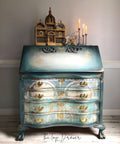 WoodUBend Ring Applique #1520 (set of 2) is the perfect mouldable embellishment for any project! A blue and white blended dresser with gold accents on the front, featuring these moulds on the top in the center of the dresser.