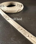 WoodUBend Trim #TR705 (Set of 2) is the perfect mouldable embellishment for any project!  A rolled up strip of WoodUBend sitting on a black table, unrolling at one end.