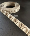WoodUBend Trim #TR718 (Set of 2) is the perfect mouldable embellishment for any project!  A roll of WoodUbend sitting on a brown table, unrolling at one end.